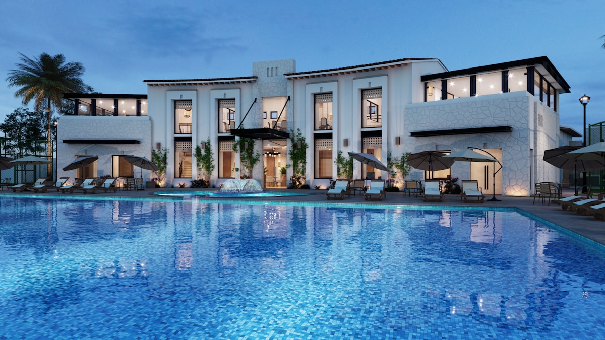 Villa with pool and palm trees at dusk